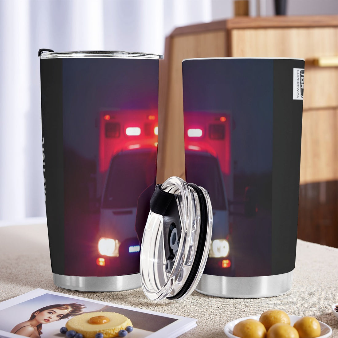 A person stands in front of an ambulance with its lights on, facing away from the camera.