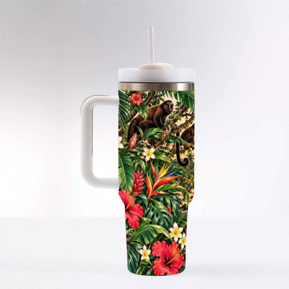 A tall insulated tumbler with a handle and a lid, featuring a vibrant tropical print design depicting various flora and fauna.