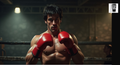 A muscular man wearing red boxing gloves stands in a boxing ring, looking determined and focused.